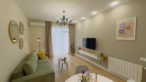a living room with a couch and a table at Parkside Dighomi in Tbilisi City