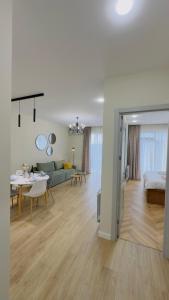 a large living room with a couch and a table at Parkside Dighomi in Tbilisi City