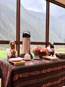 a table with two stuffed animals sitting on top of it at Boutique Inka Hotel in Ollantaytambo