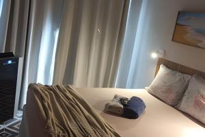 a bedroom with a bed with a hat on it at Lotf Privativo in Volta Redonda