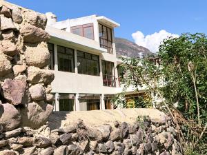 a stone wall in front of a house at Boutique Inka Hotel in Ollantaytambo