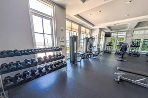 a gym with lots of equipment and lots of windows at 314S Nautical Beach Suite - 2 Beds!, Pools, Jacuzzi, Beach, Shops & Dog Friendly in Boynton Beach
