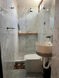 a bathroom with a sink and a toilet and a mirror at Menacho's House in Caraz +31 photos