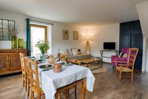 a living room with a table and a couch at La Maison d'Adèle in Baden
