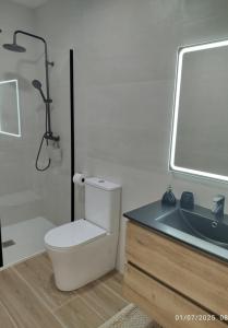 a bathroom with a toilet and a sink at Casa do Coto in Islote de Chilreu +12 photos