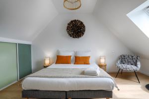 a bedroom with a large bed and a chair at La Maison d'Adèle in Baden