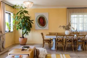 a living room with a table and chairs at Azurara Guesthouse in Azurara