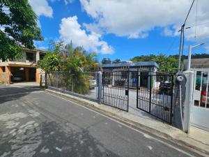 an iron fence on the side of a street at Caribbean Domicil Apartment 02 in Las Terrenas