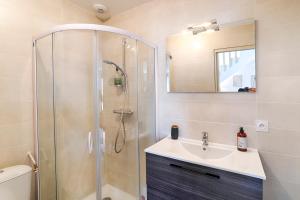 a bathroom with a shower and a sink and a mirror at La Maison d'Adèle in Baden +12 photos