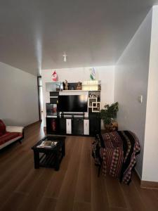 a living room with a flat screen tv and a couch at Menacho's House in Caraz