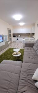 a living room with a large couch and a table at Apartament Silvi Super View in Varna City