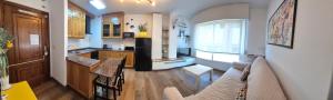 a kitchen with a couch and a table in a room at APARTAMENTO ALECRIN Padrón in Padrón +3 photos