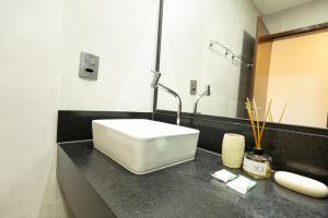 a bathroom with a white sink and a mirror at Pousada do Nica in Fernando de Noronha +63 photos
