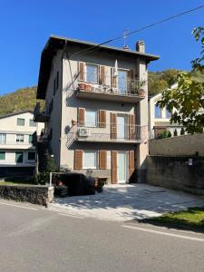 an apartment building with balconies on the side of a street at Cà Marasciol in Villa di Tirano