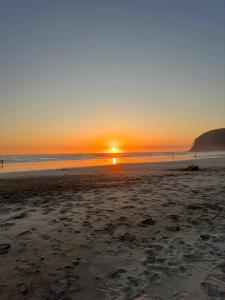 a sunset on a beach with the sun setting at MarLis in Quebrada Seca