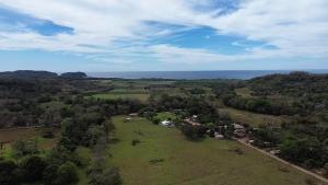 an overhead view of a field with trees and the ocean at MarLis in Quebrada Seca