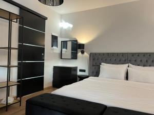 a bedroom with a large bed with a black headboard at Apollonio Suites in Korinthos