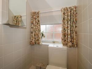 a bathroom with a toilet and a window at Cariad Cottage in Ludlow +18 photos