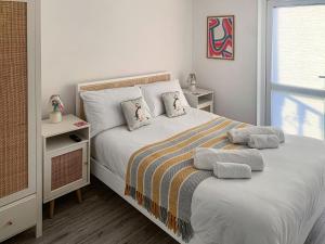 a bedroom with a bed with two pillows on it at Seaspace in Bacton
