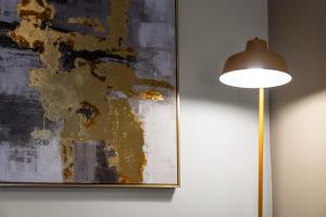 a lamp and a painting next to a wall at 1-Bed Duplex with Sofa Bed in Airdrie Lanarkshire - Long Stays - Free Parking in Airdrie