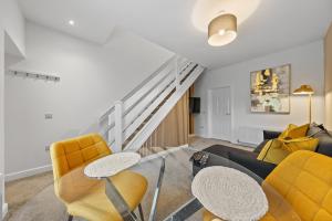 a living room with yellow chairs and a couch at 1-Bed Duplex with Sofa Bed in Airdrie Lanarkshire - Long Stays - Free Parking in Airdrie