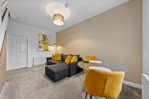 a living room with a couch and a table at 1-Bed Duplex with Sofa Bed in Airdrie Lanarkshire - Long Stays - Free Parking in Airdrie