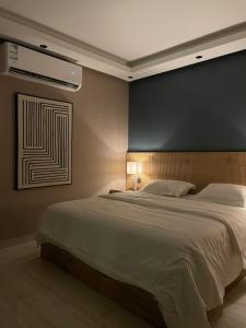 a bedroom with a large bed with a black wall at Cali chalets in Riyadh +41 photos