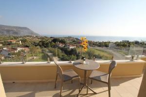 a table and chairs on a balcony with a view at I Settembrini in Capo Vaticano