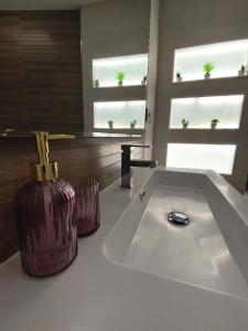 a bathroom with a large white bath tub with a vase at Curros in Ponte Do Porto +33 photos