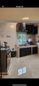 a kitchen with a stove and a counter top at Oasis de Moanda 1 in Libreville