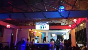 a crowd of people in a room with a projection screen at VEGAS Motel in Kigali