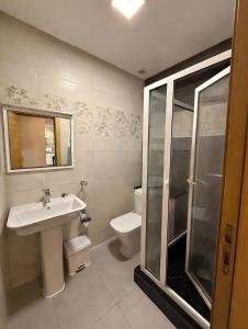 a bathroom with a sink and a toilet and a shower at Appart Hotel Bloom in Al Hoceïma