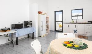 a kitchen with a table with a plate of fruit on it at The North Atlantic Sands Beach House in Velddrif +2 photos