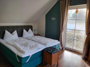 a bed in a room with a large window at Lenzer Parkblick am Plauer See in Lenz