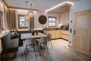a kitchen and dining room with a table and chairs at BRUGGER ChaletDorf in Mayrhofen +61 photos