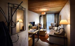 a living room with a couch and a table at Chalets Jasná Centrum APARTMENT S - Free Jacuzzi & Sauna and Chopok view in Belá