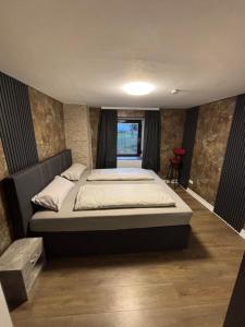 a bedroom with a large bed in a room at Haus am Freilinger See Bar in Blankenheim