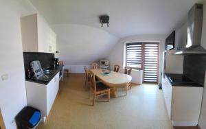 a kitchen and dining room with a table and chairs at Ferienwohnung Fröse in Altenbeken