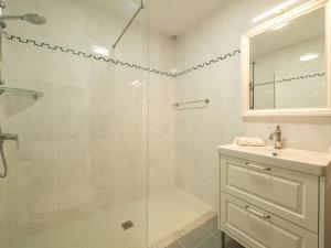 a white bathroom with a shower and a sink at Alta Mar Apartment by 3VILLAS in Son Bou +22 photos