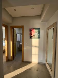 a bathroom with a toilet and a picture on the wall at Appart Hotel Bloom in Al Hoceïma