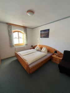 a bedroom with a large bed and a window at Haus Bergblick in Obertauern