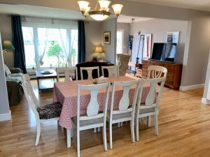 a dining room and living room with a table and chairs at 101 Harborview Drive in North Rustico