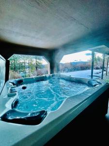 a large bath tub with blue water in it at Lake View on Lookout Coeur d' Alene ID in Coeur d'Alene