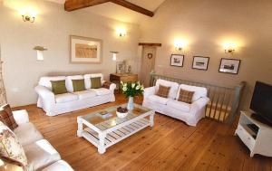 a living room with two white couches and a coffee table at Winnow Barns Holidays in Ashbourne