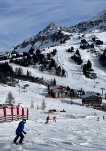 a group of people skiing down a snow covered mountain at Haus Bergblick in Obertauern