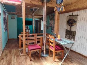 a dining room and kitchen with a table and chairs at Casa familiar chana 388 in Puerto Montt