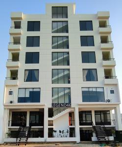 an apartment building with a sign that reads leerkos at Oasis Living in Islamabad