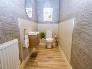 a bathroom with a toilet and a sink at 2 Glan Yr Aber in Colwyn Bay +33 photos
