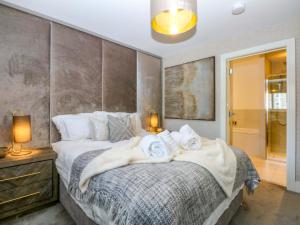 a bedroom with a bed with towels on it at 2 Glan Yr Aber in Colwyn Bay