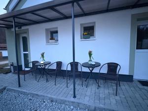 a group of tables and chairs on a patio at Jedlinka in Palota